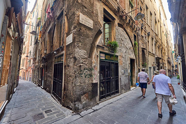 Genova, Italy - August 17, 2016: tourists visiting Via Di Canneto, one of the many narrow street of Genoa Old Center, locally known as \