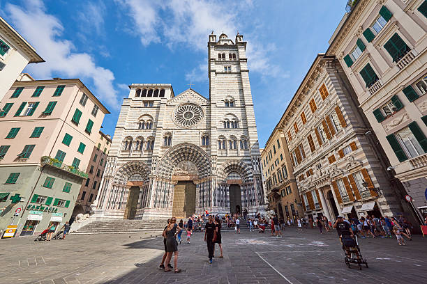 Genova, Italy - August 17, 2016: locals and tourists roaming outside San Lorenzo Cathedral, the most important religious building of the city.