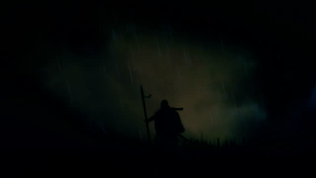 A Warrior Standing Alone in a Field Under Storm