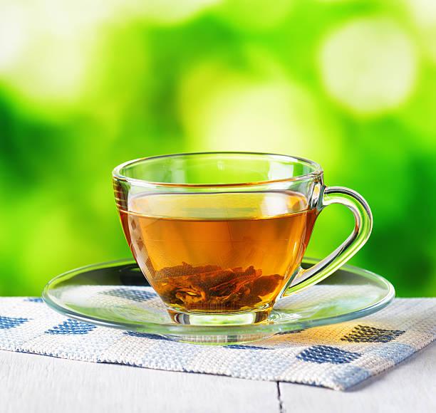 istock Cup of tea on nature background 597628768