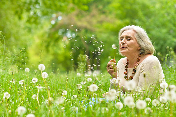 istock Senior woman in green park 597629108