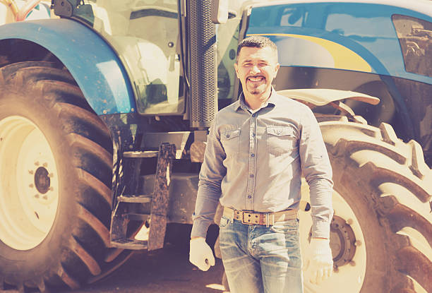 istock Mature farmer near tractor 597631122
