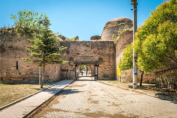 Iznik, Turkey - July 24, 2016: Couple people are  passing through Istanbul gate of Nicea ancient city in Iznik, Turkey