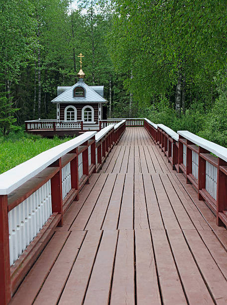 wooden pedestrian bridge painted red over the Arnoia river in Allariz. Galicia, Spain