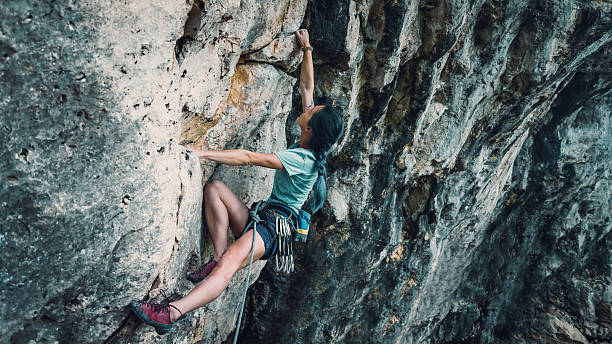 istock Woman with outfit climbing the rock 597636082
