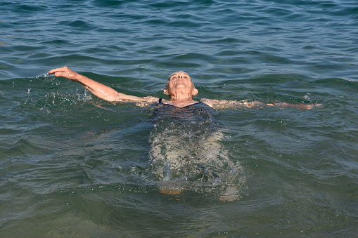 Senior woman enjoying of backstroke