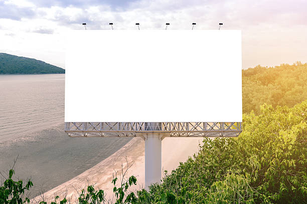 Blank billboard with beautiful beach for advertisement. stock photo