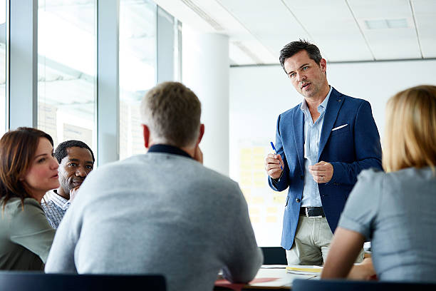istock Leading the team through his business plan 597639824