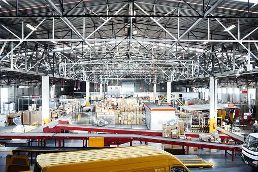 Shot of a large distribution warehouse full of boxes and containers