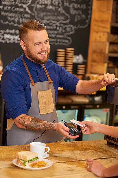 istock Barista taking contactless payment 597641094
