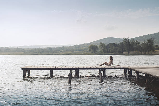 istock Lonely girl at the dock 597641376