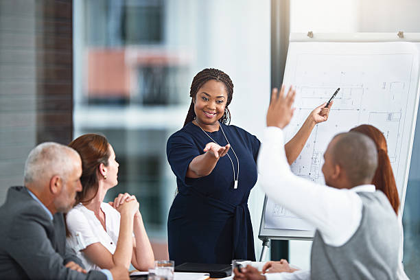 Sharing some constructive feedback Cropped shot of a businesswoman giving a presentation to her colleagues in a boardroom constructive feedback stock pictures, royalty-free photos & images