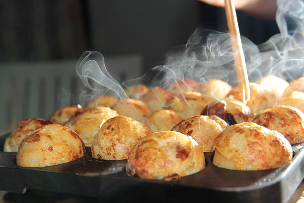 Aroma smell of hot cooking,Tokayaki grilling,on selective focus. Takoyaki is hot street food to be  popular. takoyaki stock pictures, royalty-free photos & images