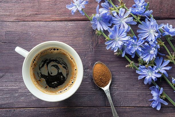 Chicory drink with blue flowers Chicory foam drink on wooden table and powder in spoon chicory stock pictures, royalty-free photos & images