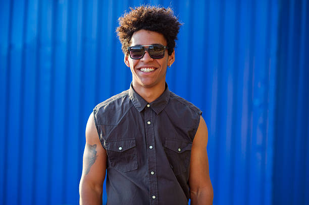istock Funky young man portrait over blue background. 597642968
