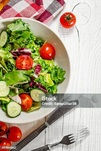 Salad Of Tomatoes And Cucumbers With Greens Stock Photo - Download Image Now - Arugula, Backgrounds, Basil