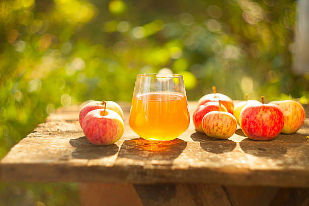 Apple juice in glass on  table stock photo