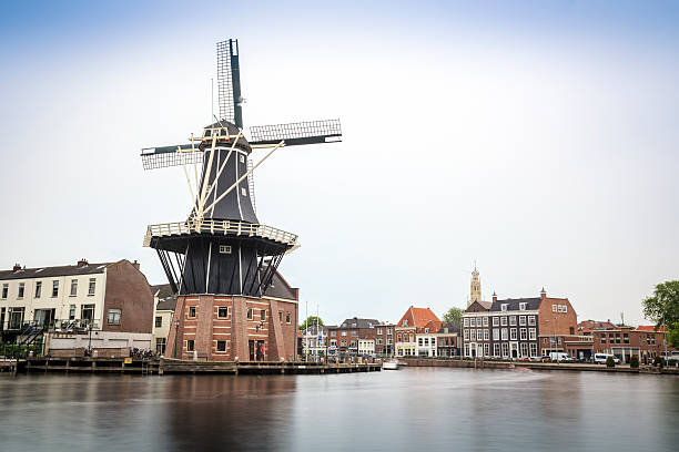 istock Haarlem by canal with windmill, The Netherlands 597647356