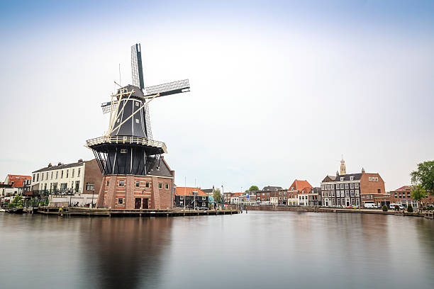 istock Haarlem by a canal with windmill, The Netherlands 597647664
