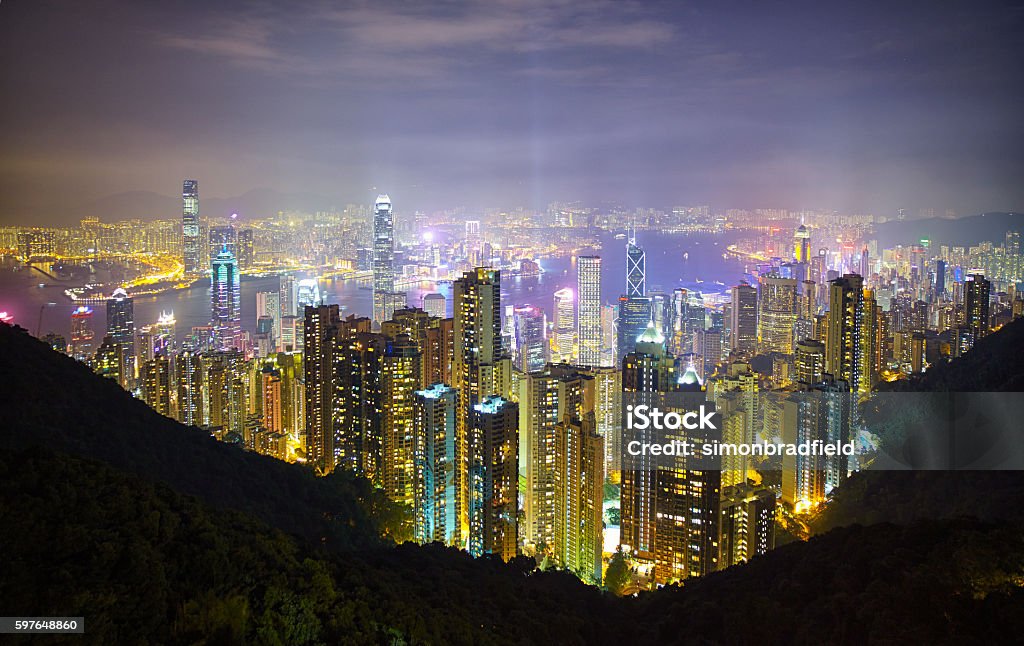 Hong Kong Island From The Peak Evening descends upon Hong Kong, and this is the view of the skyscrapers of Hong Kong Island & Kowloon from the Peak.  Apartment Stock Photo