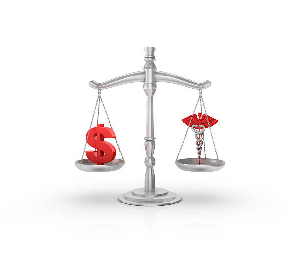 istock Scale with Dollar Sign and Medical Symbol 597649848
