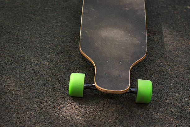 istock Old used skateboard isolated on the ground. 597652396