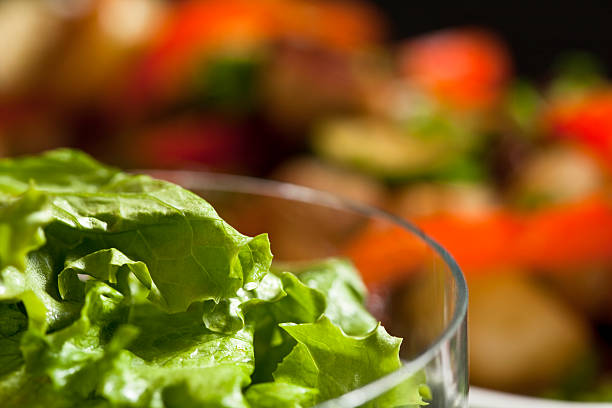 istock Glass Bowl with Green Lettuce with Blurry Colourful Background 597654724