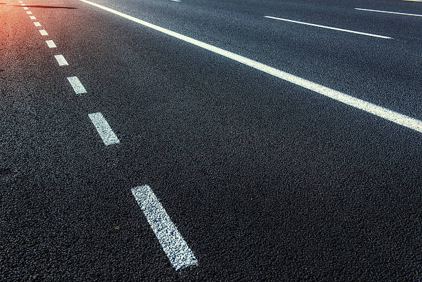 istock Asphalt road along the sea at sunset. 597656266