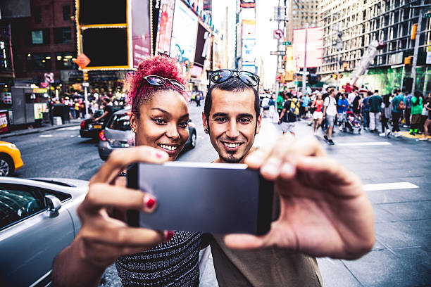 istock Tourist couple take a selfie in Times Square 597656654