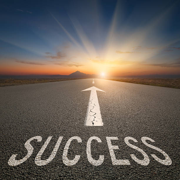 istock Business concept on an open road with success text 597657320