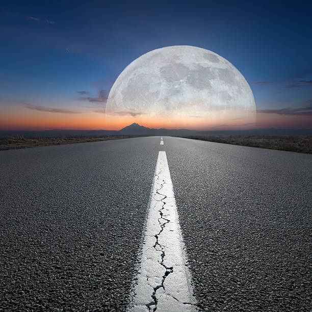 istock Driving on open road towards the mountain and big planet 597658066