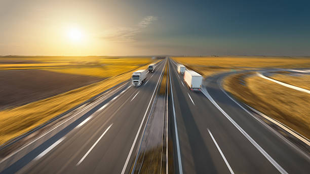 istock Speed concept with trucks on the highway at idyllic sunset 597658954