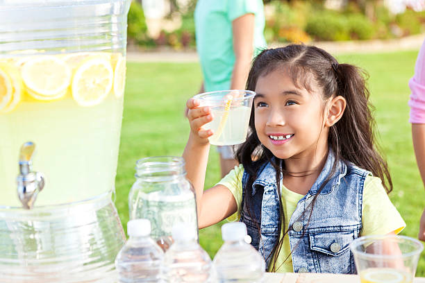 istock Confident little girl sells lemonade 597659068