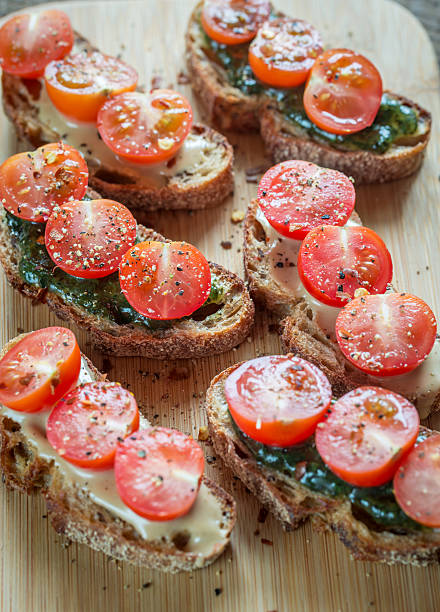 istock Toasts with tahini and mint sauce and cherry tomatoes 597659970