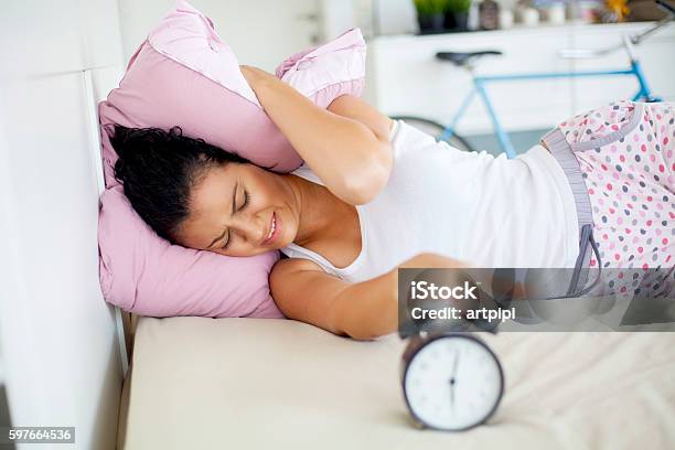 Young Woman Trying Not To Wake Up Stock Photo - Download Image Now - Alarm Clock, Morning, Adult