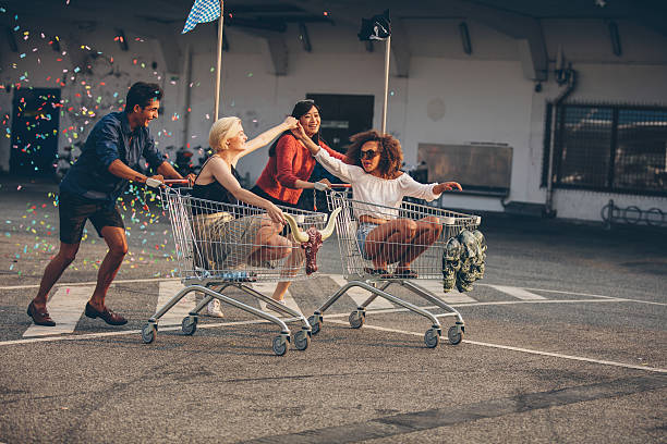 istock Young friends racing with shopping carts 597665430