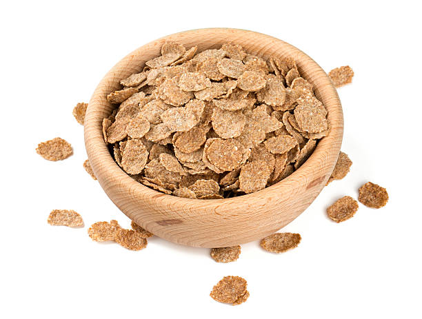 pile of bran flakes isolated on white pile of bran flakes isolated on white bran flakes stock pictures, royalty-free photos & images