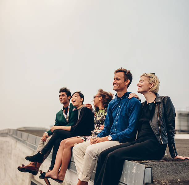 istock Multiracial friends enjoying on terrace 597666048