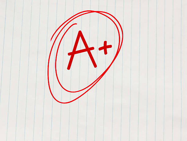 The grade A plus (A+) written in red on notebook paper A plus (A+) grade written in red on notebook paper report card stock pictures, royalty-free photos & images