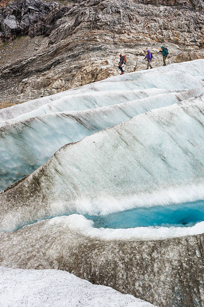 istock Dramatic walk across icy glacier with crevasses 597669160