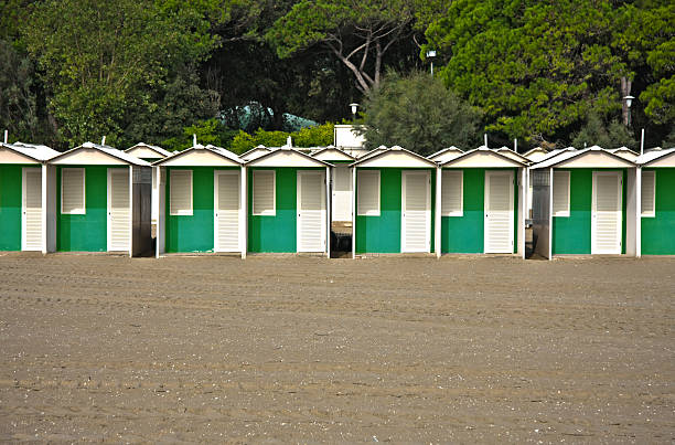 istock Row of colourful beach huts on a sandy beach 597669862