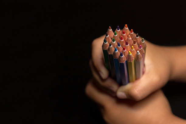 istock Child's hands with pencils, back to school. Colorful pencils. 597670098