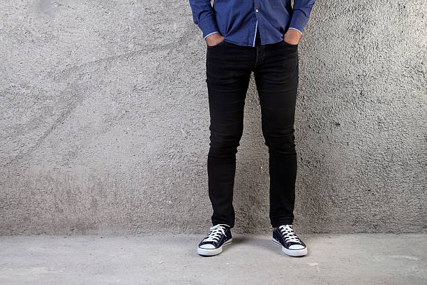 istock Young man standing on a concrete floor 597670692