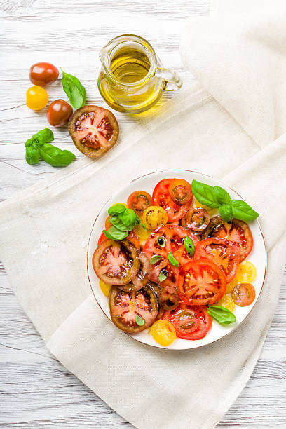 istock Colorful Tomato Salad with Basil 597673744