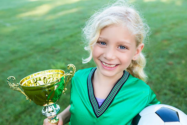 istock Excited soccer champion with trophy 597673750