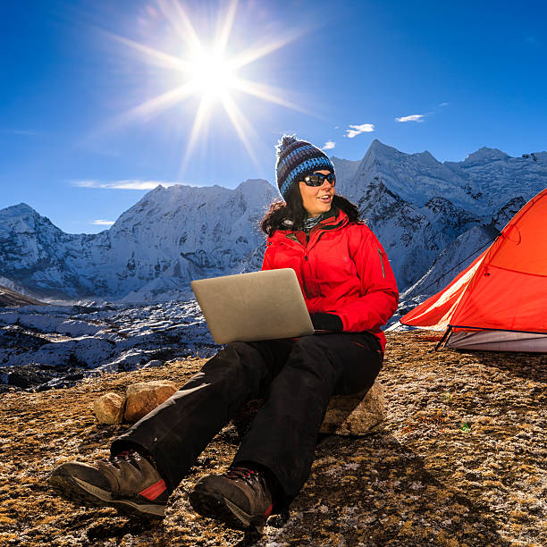istock Young woman using laptop in Himalayas, Nepal 597927710