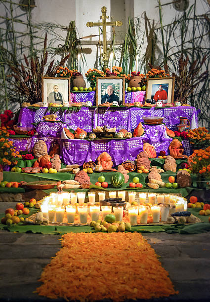 Day of the dead altar Cuernavaca, Mexico - November 2, 2013: Traditional day of the dead altar with pan de muerto and candles. Festivity celebrated throughout Mexico in October 31, November 1 and November 2 cuernavaca stock pictures, royalty-free photos & images