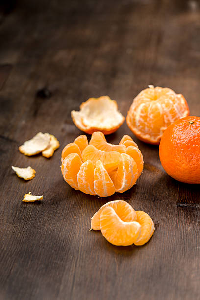 istock Clementines as a whole and as pieces to a background 597928372