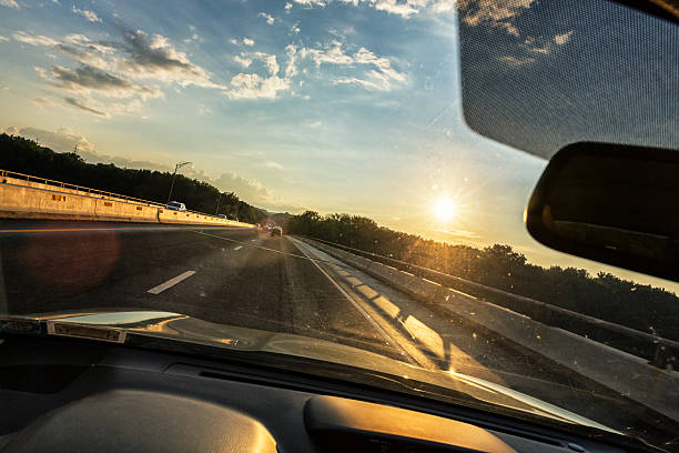 istock Expressway Bridge Driving POV Sunset Through Speeding Car Windshield 597928890
