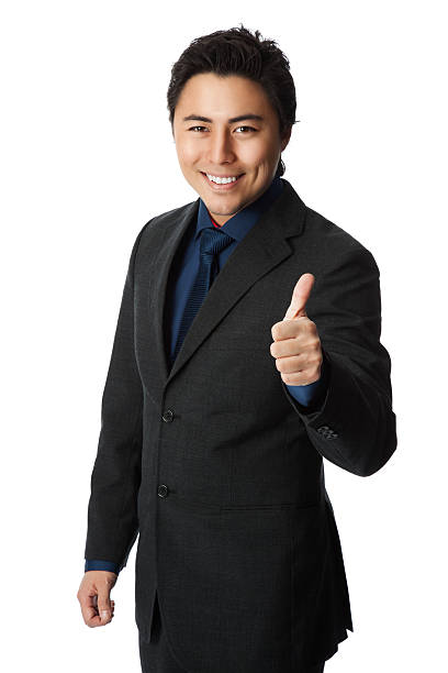 istock Good looking businessman in suit with thumbs up 597930858
